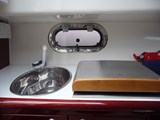 Galley showing sink tap and hob (with 220V sockets in background)